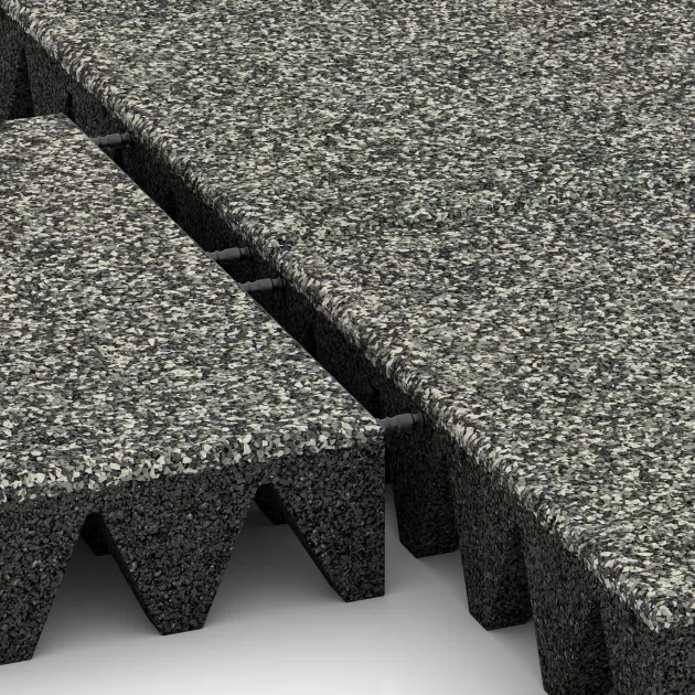 Großaufnahme vom Verbindungssystem von WARCO-Boden 5644 - Rubber speelplaatstegel 10 cm - EN 1177 ≤ 300 cm im Farbdesign Grijs Graniet. Abmessungen 500 x 500 x 100 mm.