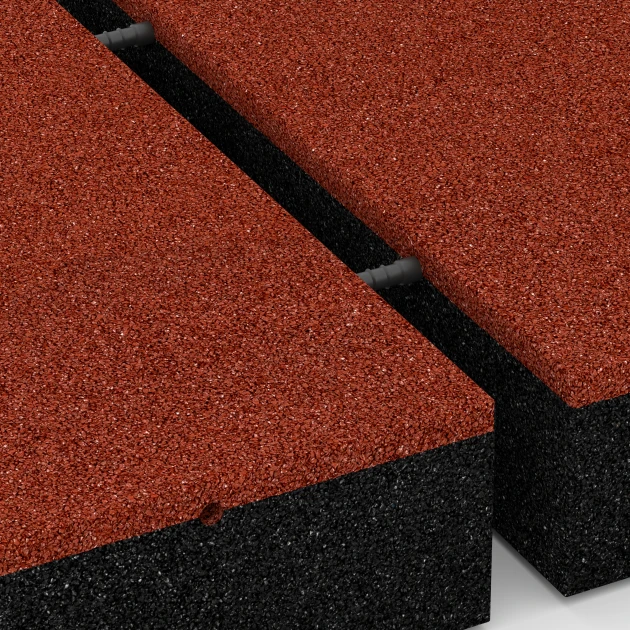 Großaufnahme vom Verbindungssystem von WARCO-Boden 6278 - Rubberen speelplaatstegel – 300 cm im Farbdesign Baksteenrood. Abmessungen 50 x 50 x 11 cm.